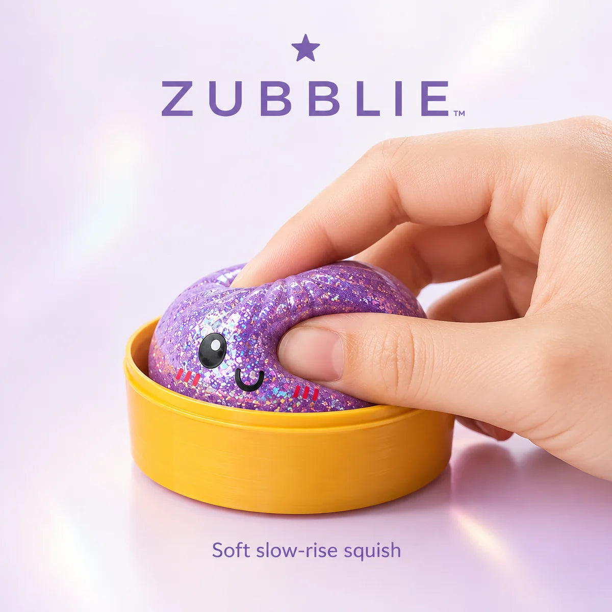 A hand squeezing a glitter dumpling toy
